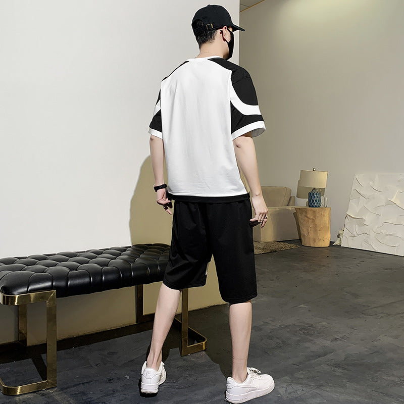 Person wearing a black and white outfit in an indoor setting