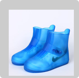 Pair of blue rain boots on a white background