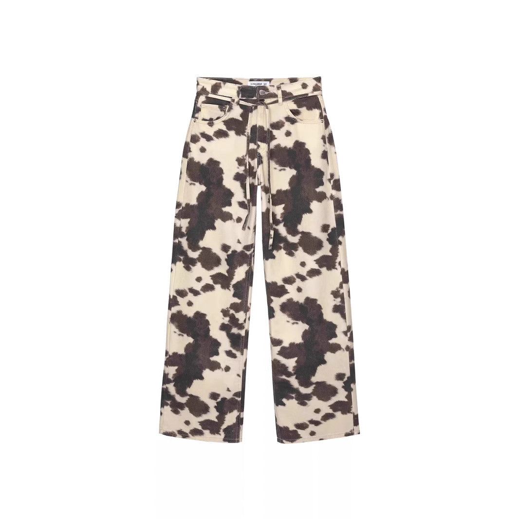 Cow print pants on a white background