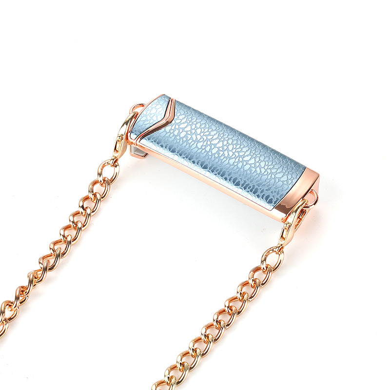 Luxury jewelry with blue gemstone and rose gold chain on a white background