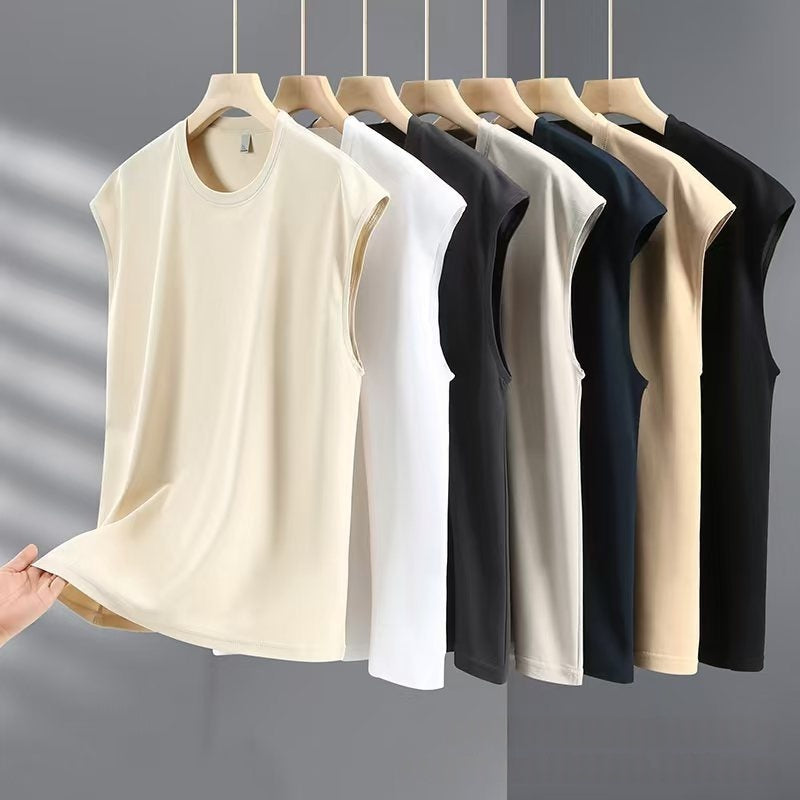 Row of sleeveless shirts in various colors on hangers against a gray background