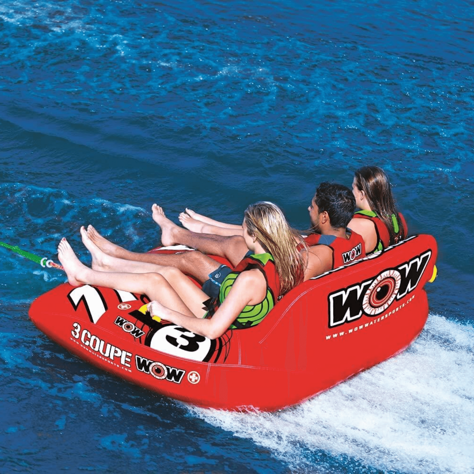 Inflatable water tube with 'WOW' branding being used by three people on a blue water background.