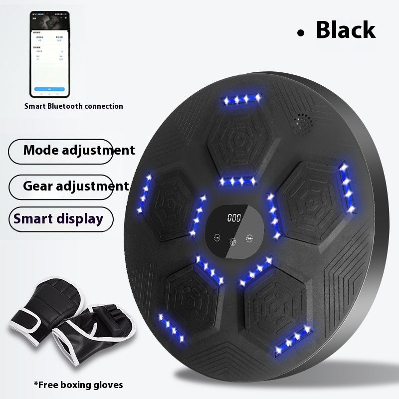 Black exercise device with blue lights and gloves on a white background