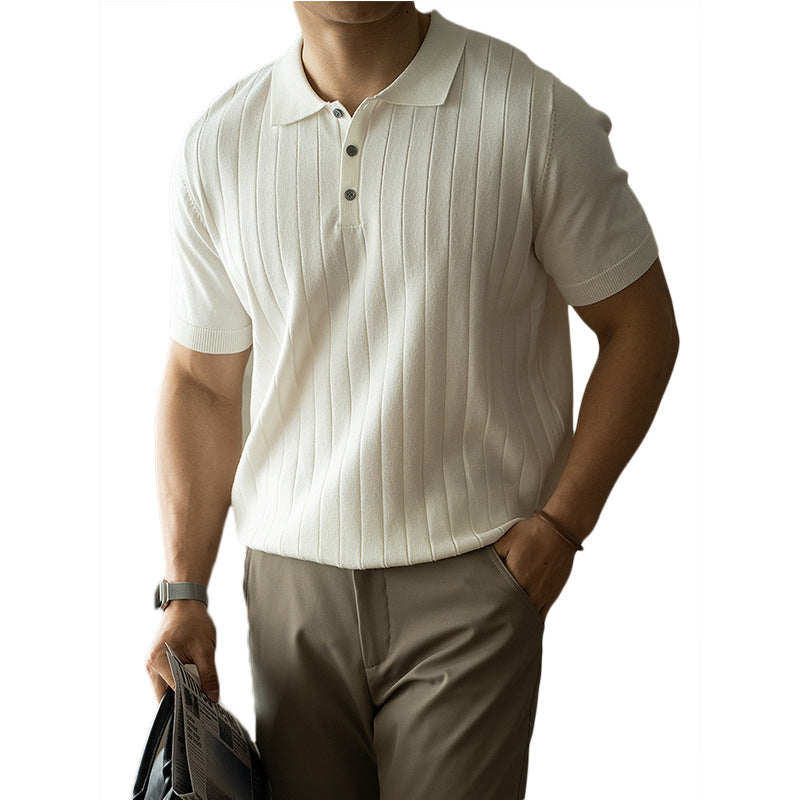 Man wearing a white ribbed polo shirt and beige pants on a white background