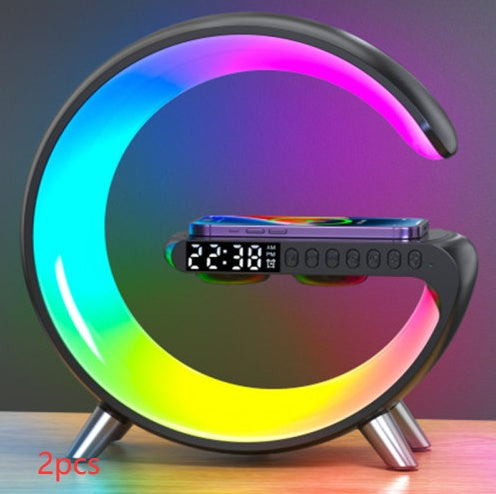 Colorful LED night light with digital clock and phone stand on a wooden surface.