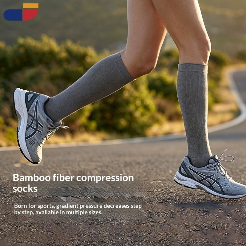 A runner's lower legs wearing gray bamboo fiber compression socks and gray running shoes on an outdoor road with blurred greenery in the background. Text on the image reads 'Bamboo fiber compression socks' with additional descriptive copy.