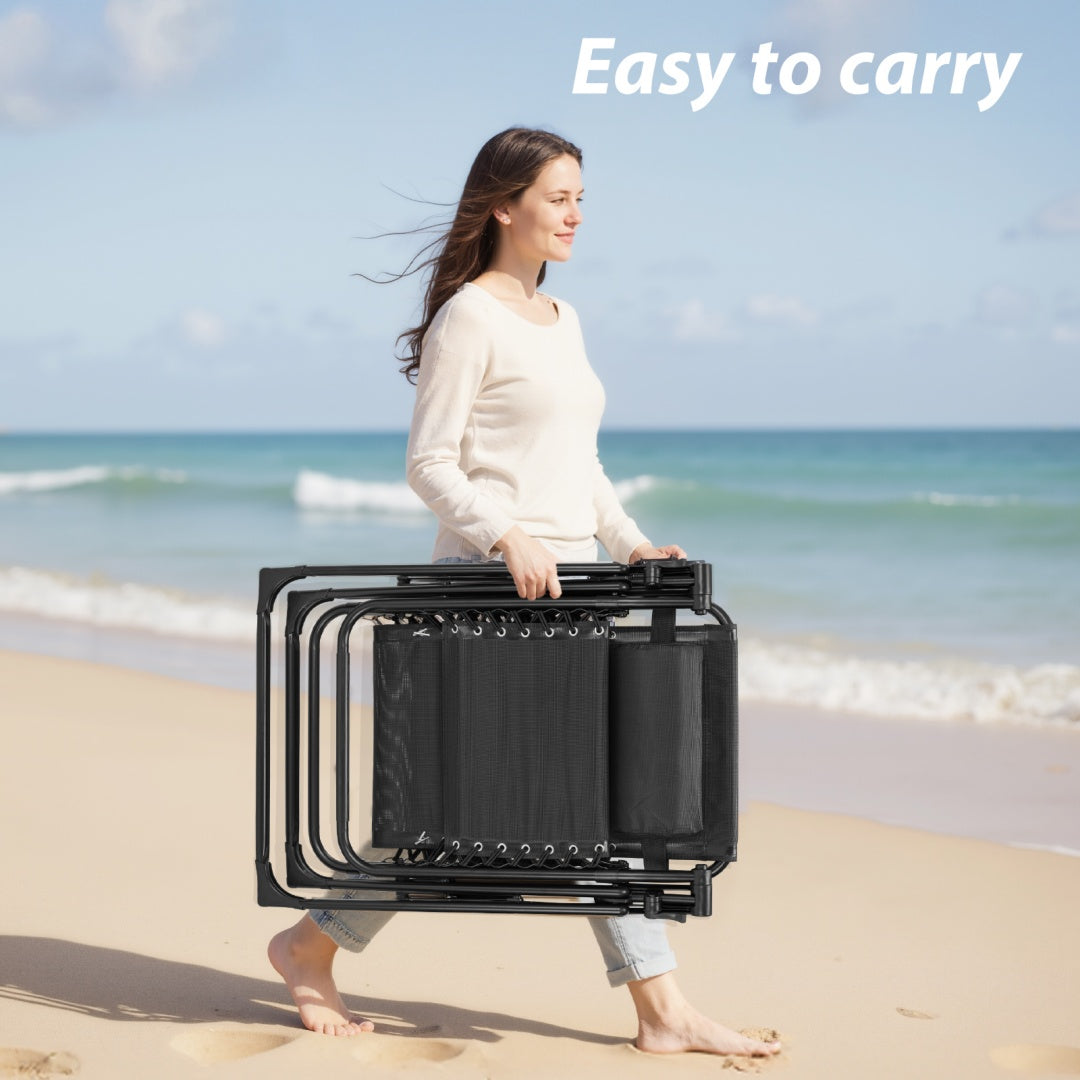 Woman carrying a folded black chair on a beach with text 'Easy to carry'.