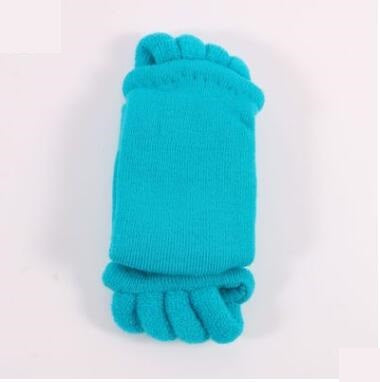 Turquoise baby booties on a white background