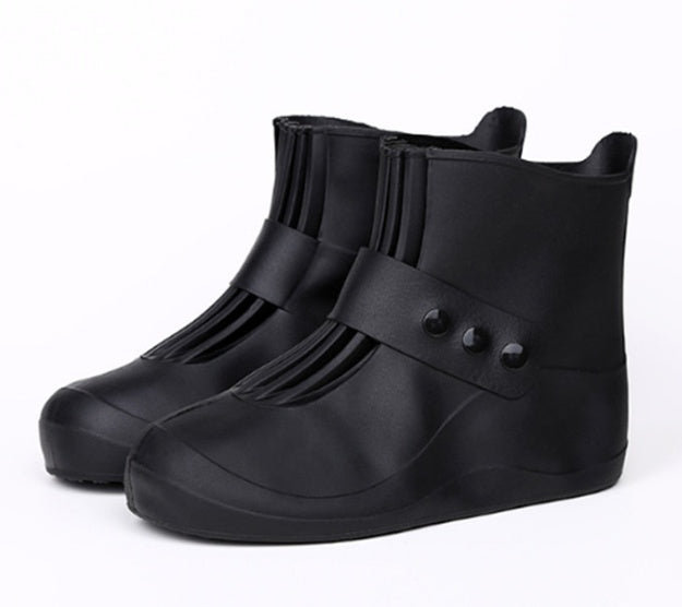 Black rubber shoe covers on a white background