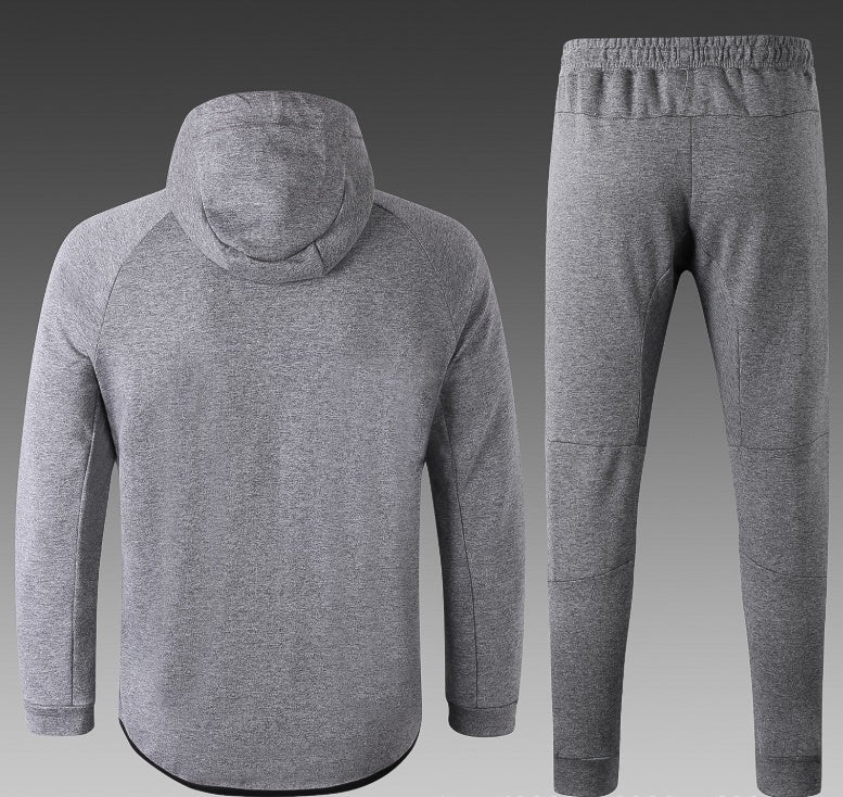 Gray tracksuit with hoodie and pants on a gray background