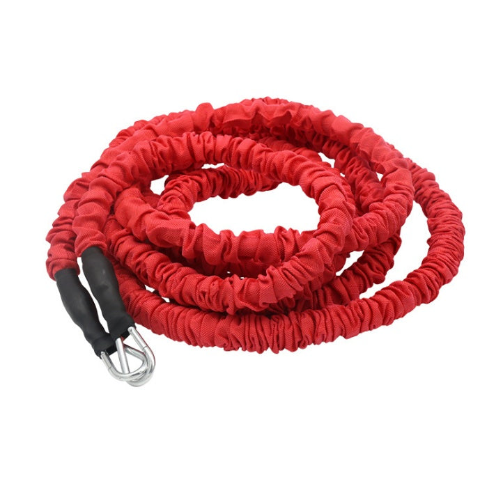 Red resistance band with black handles and a carabiner on a white background