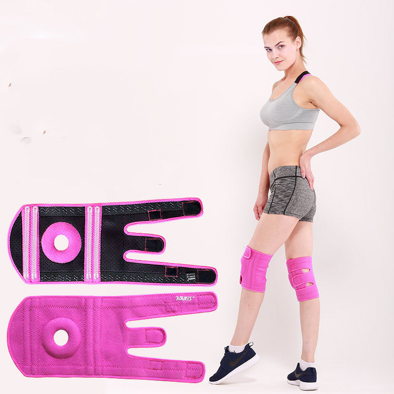 Woman wearing pink knee and elbow pads with a white background
