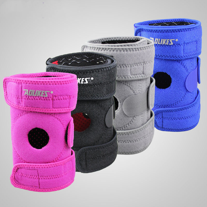 Four knee pads in pink, black, gray, and blue on a light gray background