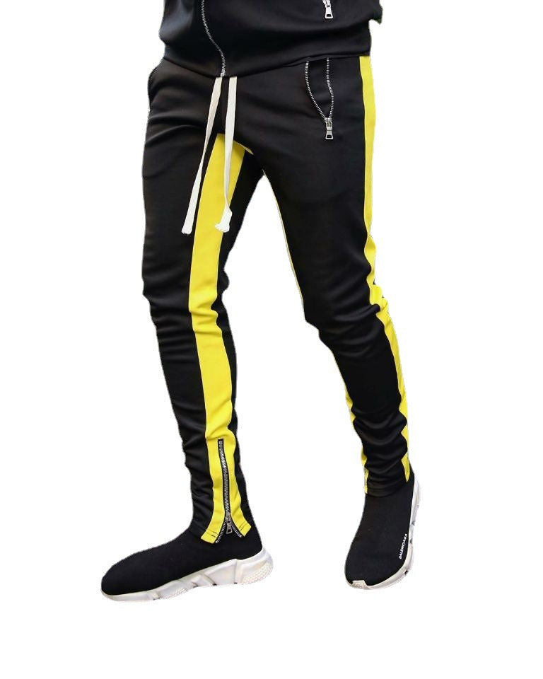Black tracksuit with yellow stripes and black shoes on a white background