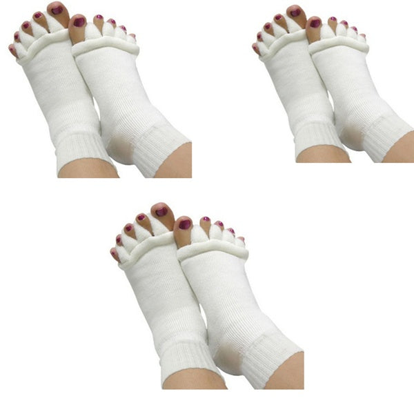 White toe separators worn on feet against a white background