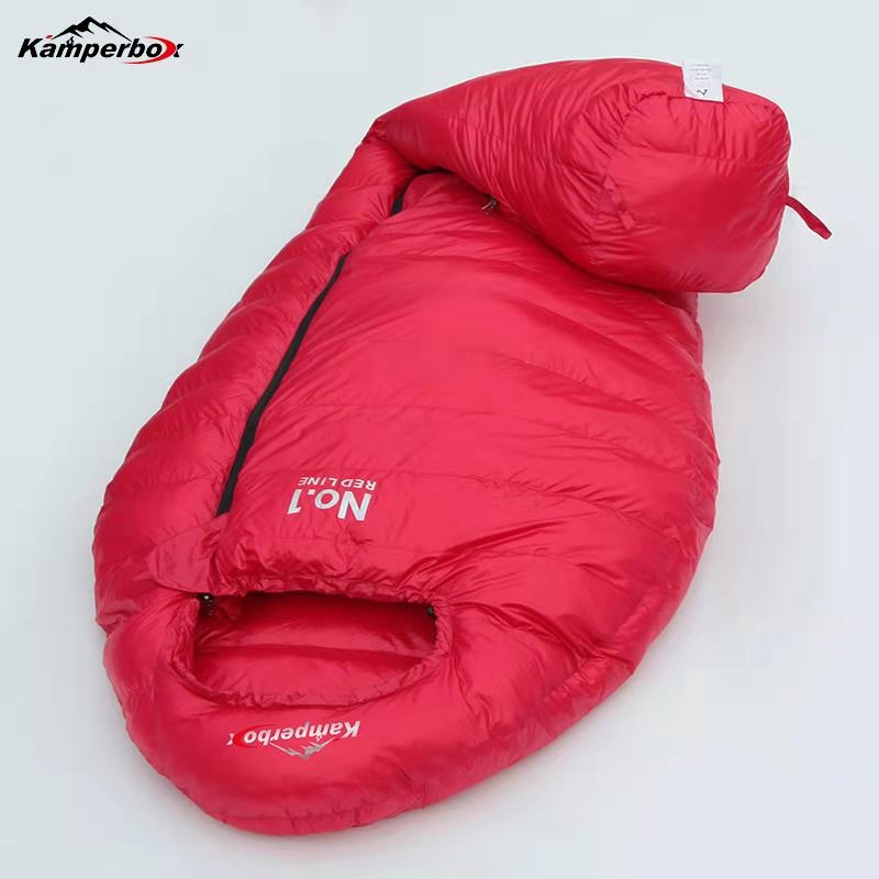 Red sleeping bag with Kamperbox branding on a white background