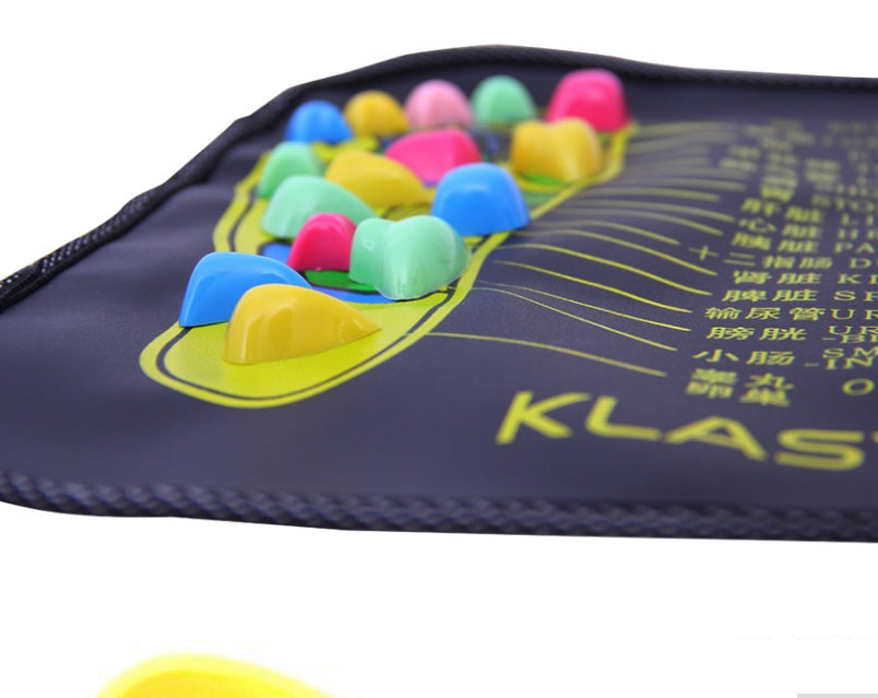 Colorful acupressure stones on a black mat with KLAS branding.