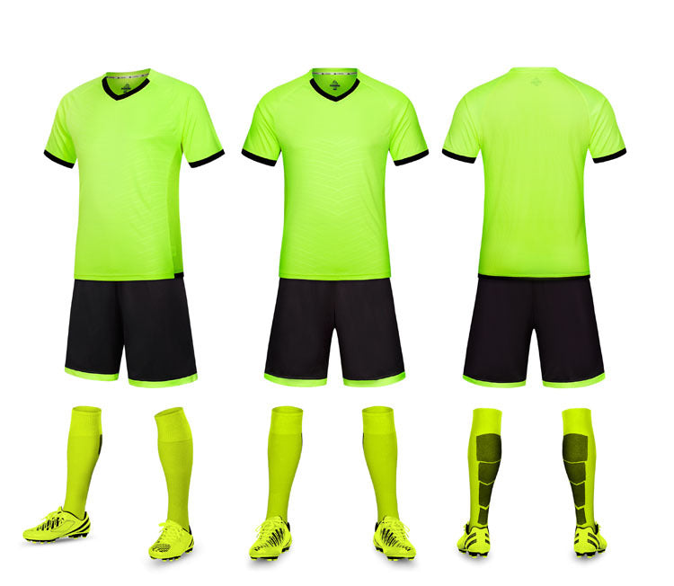 Complete soccer uniform set with bright green jerseys, black shorts, socks, and shoes on a white background.