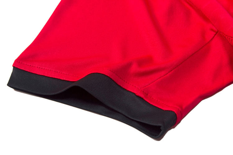 Close-up of red shorts with black trim on a white background