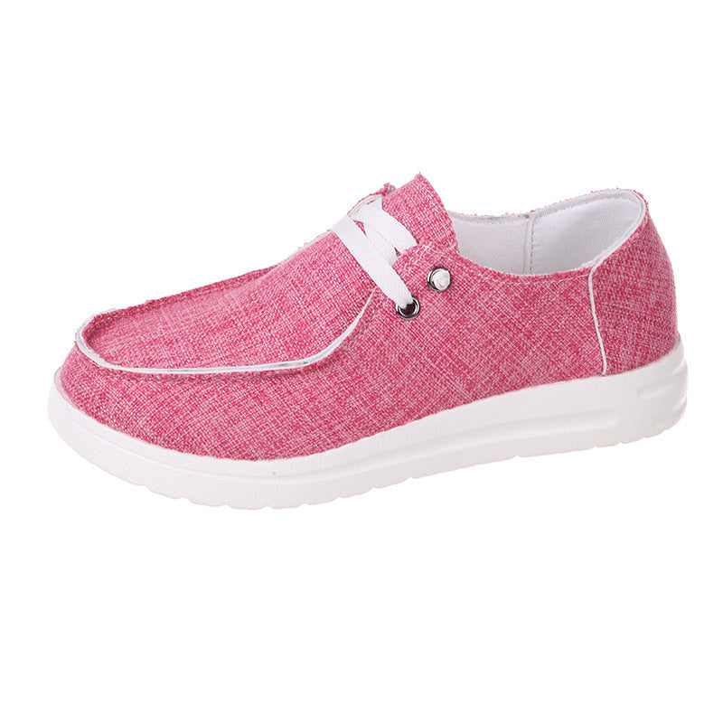 Pink casual shoe with white laces on a white background