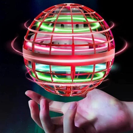 Glowing red and green spherical object held in a hand against a dark background