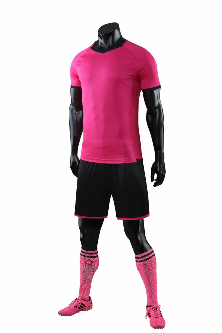 Pink soccer jersey, shorts, and socks on a mannequin against a white background
