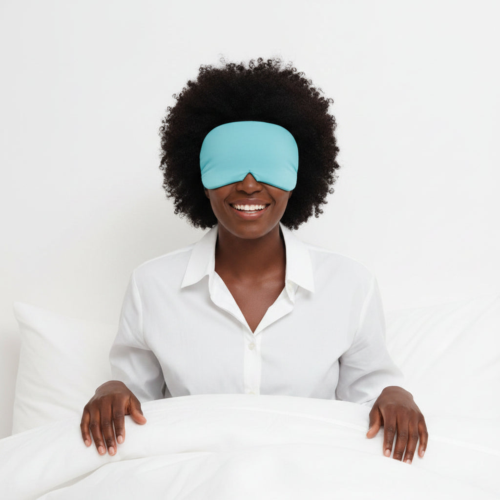 Person wearing a blue sleep mask on a white background