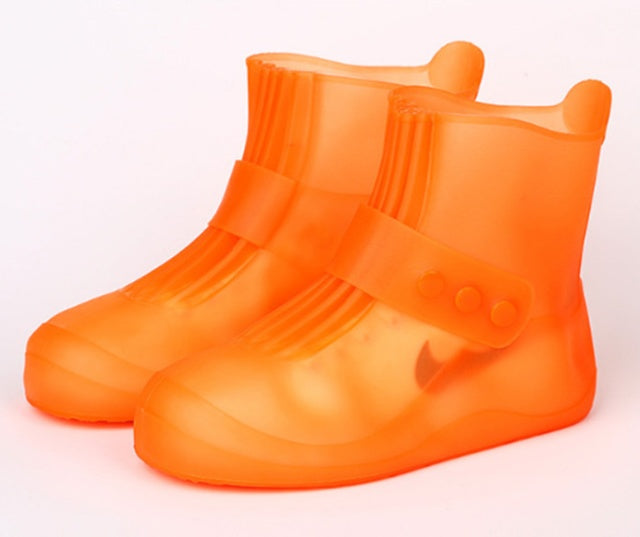 Orange rain boot covers on a white background