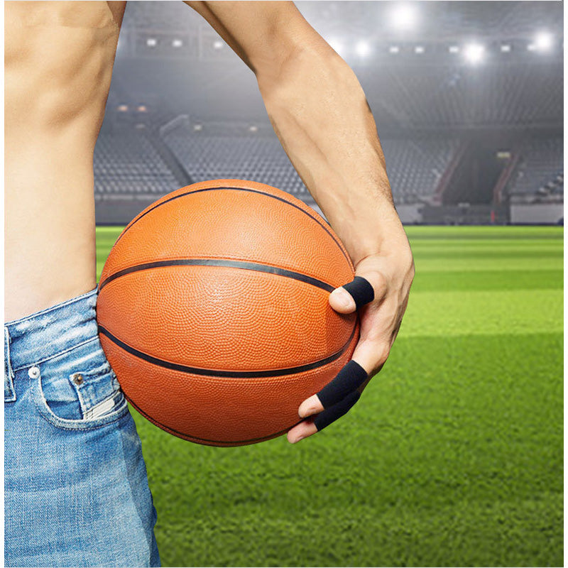 Person holding a basketball on a sports field with stadium lights in the background