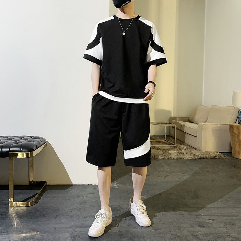 Person wearing a black and white outfit in a modern living room.