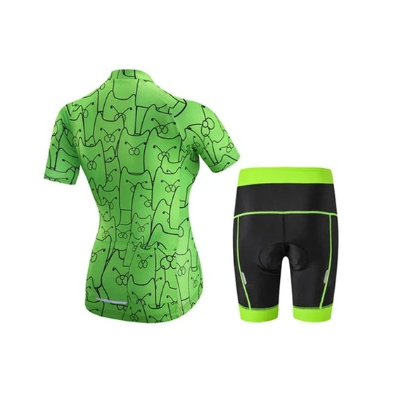 Green cycling jersey with black patterns and matching shorts on a white background