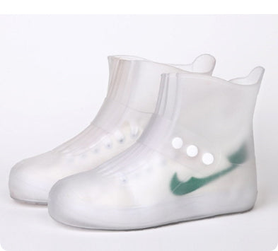Clear rain boots with a green logo on a white background