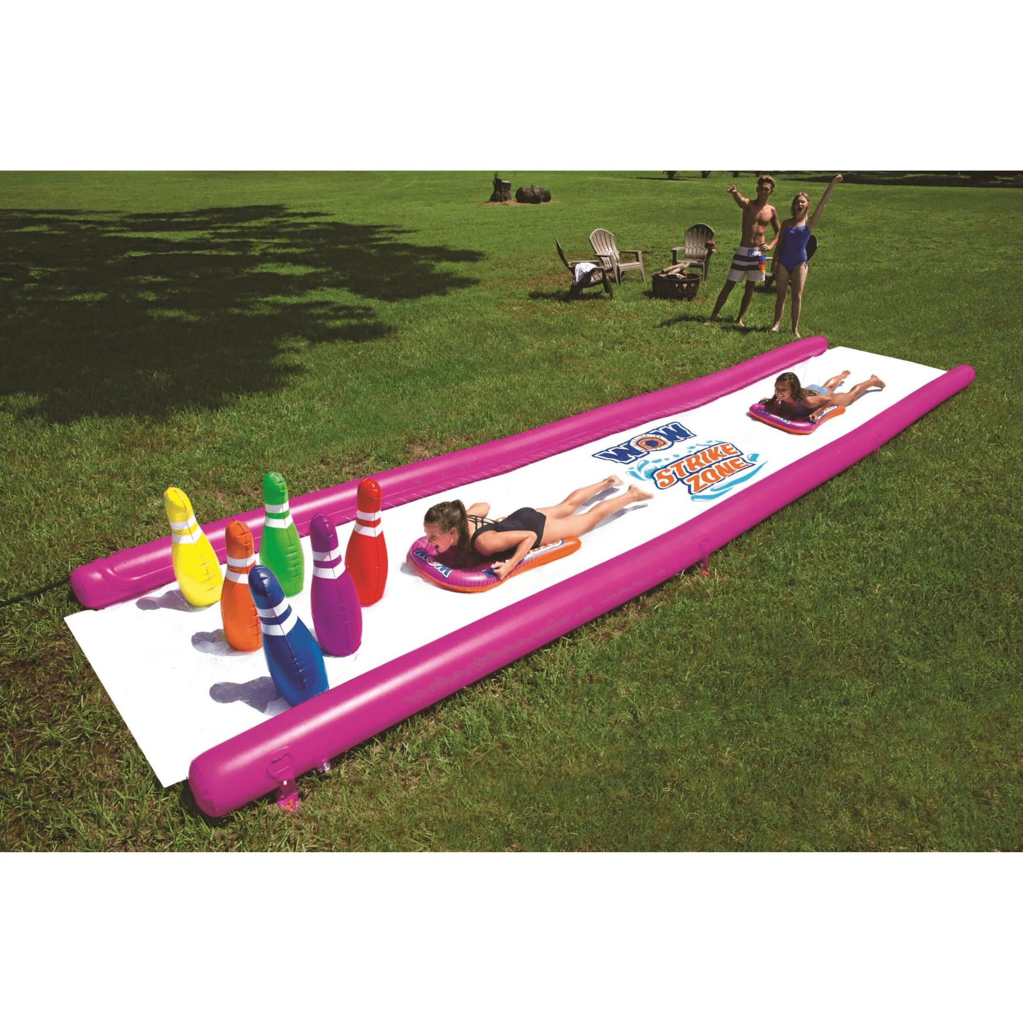Inflatable water slide with bowling pins on a grassy area