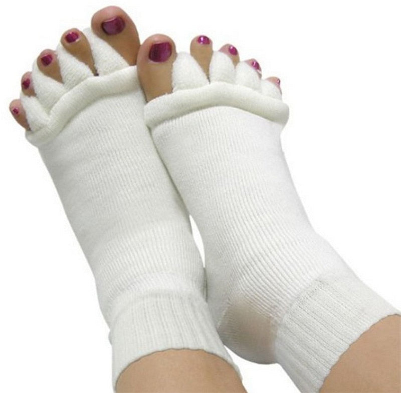 White toe separators worn by a person on a white background