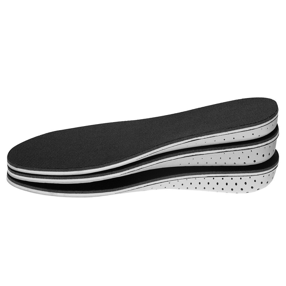 Stack of black and white shoe insoles on a white background