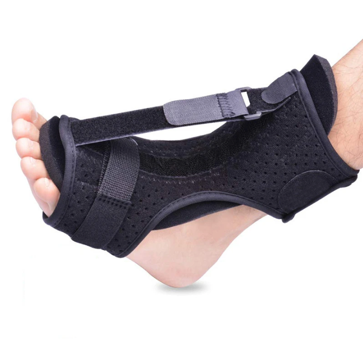 Black foot brace being worn on a white background