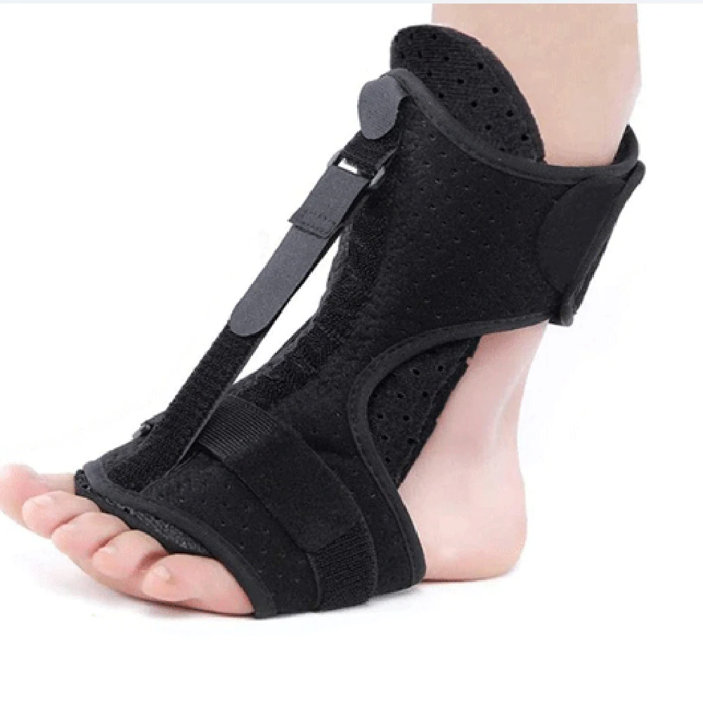 Black foot orthosis being worn on a white background