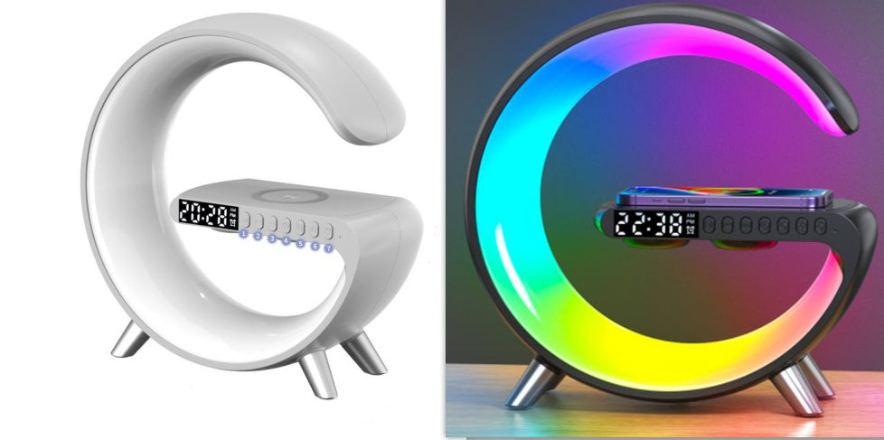 Moon-shaped alarm clock with digital display in white and black, and colorful LED light in black.