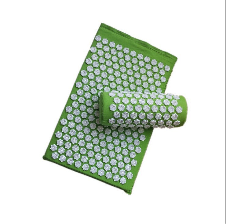Green acupressure mat with white dots on a white background
