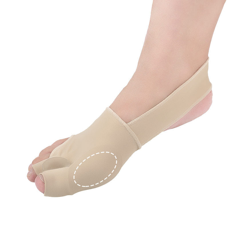 Beige bunion corrector on a foot against a white background
