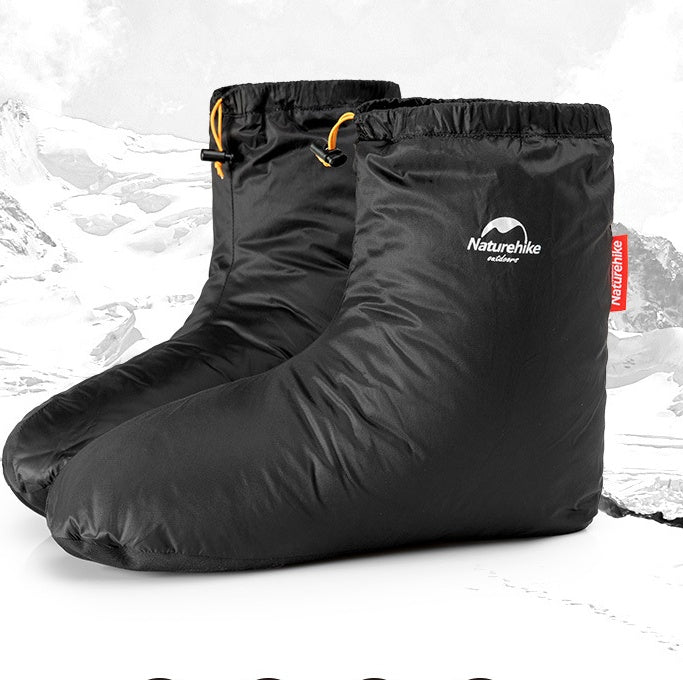 Black boot covers with 'Naturehike' logo on a snowy background