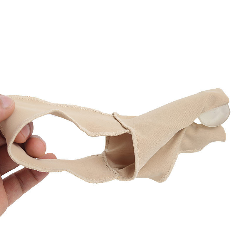 Beige silicone gel pad held by a hand on a white background