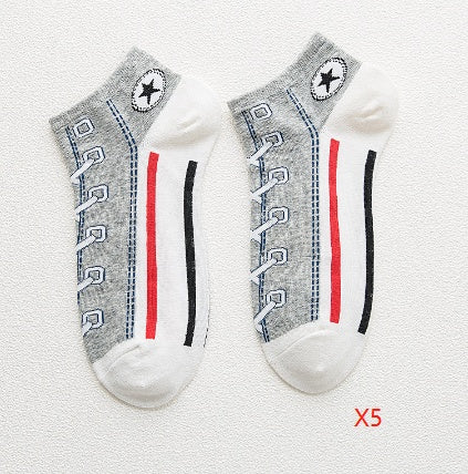 Two socks with a pattern resembling shoe laces on a light gray background