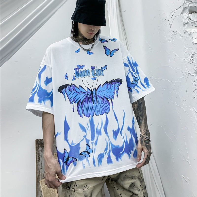 Person wearing a white t-shirt with blue butterfly designs and text against a white background