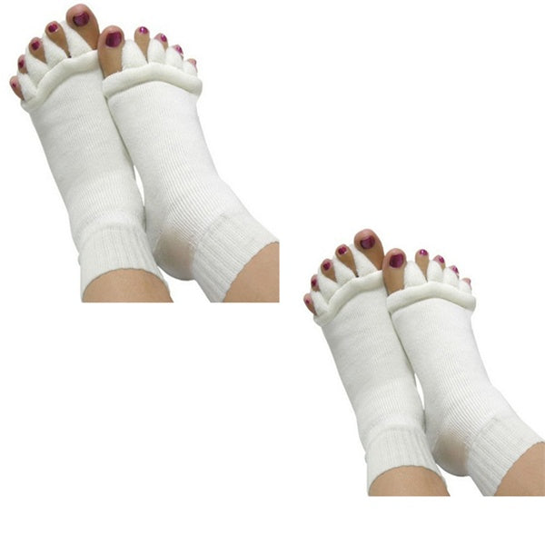 White toe separators on feet against a white background