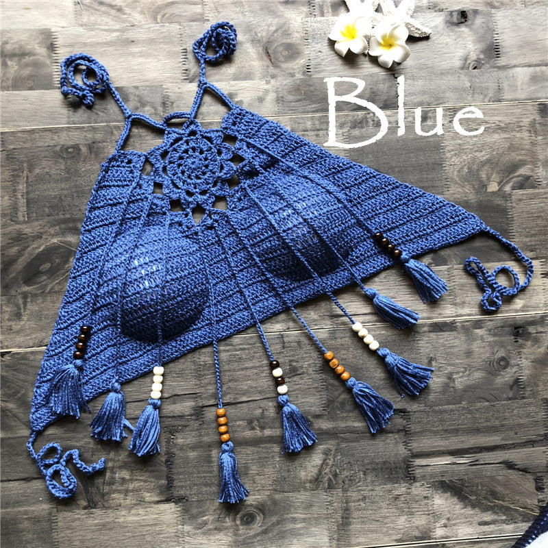Blue crocheted top with tassels on a wooden surface, labeled 'Blue'.