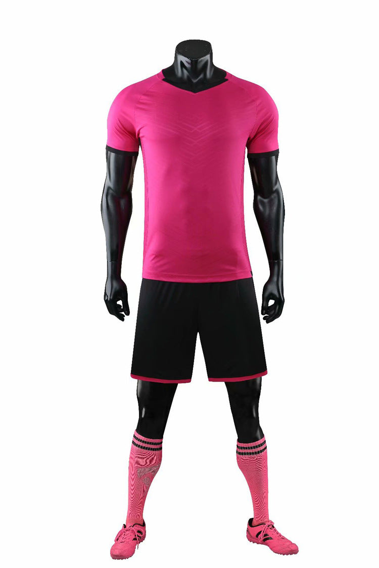 Pink soccer jersey, shorts, and socks on a mannequin against a white background