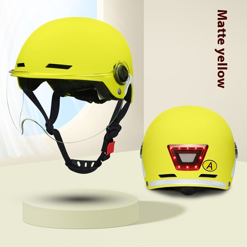 Yellow helmet with visor and rear light on a beige background