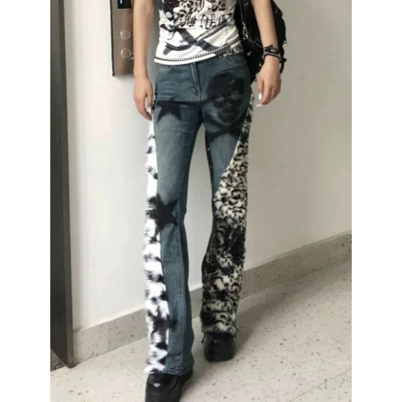 Person wearing a unique patterned jeans with a plain background
