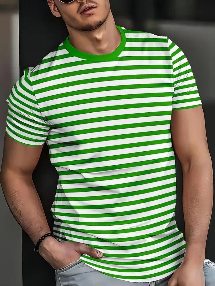 A man wearing a green and white horizontally striped short-sleeve t-shirt with a solid green crew neck, paired with light gray jeans.